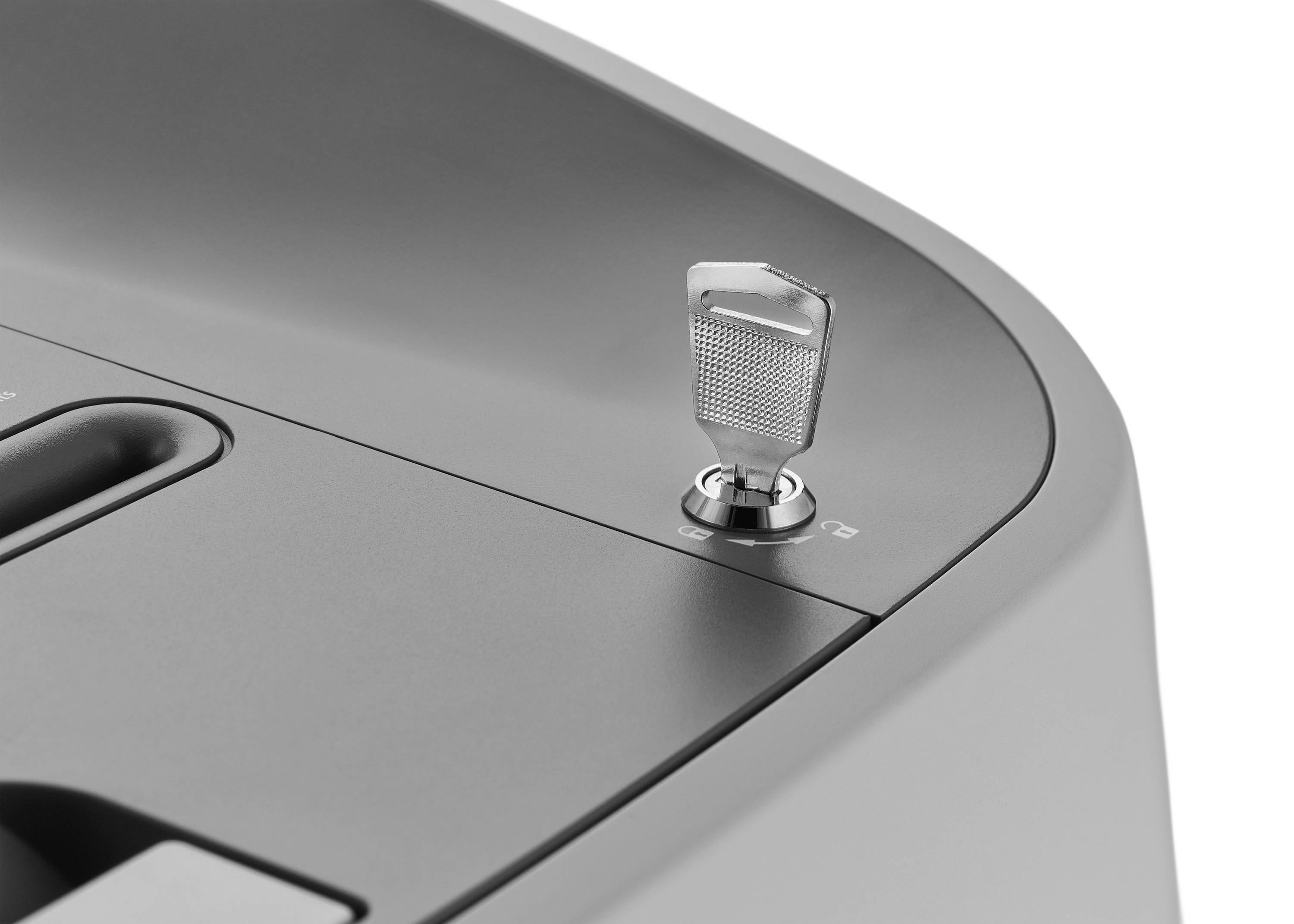 A key is inserted into an ignition lock on the top surface of a grey device. The design appears modern and functional.