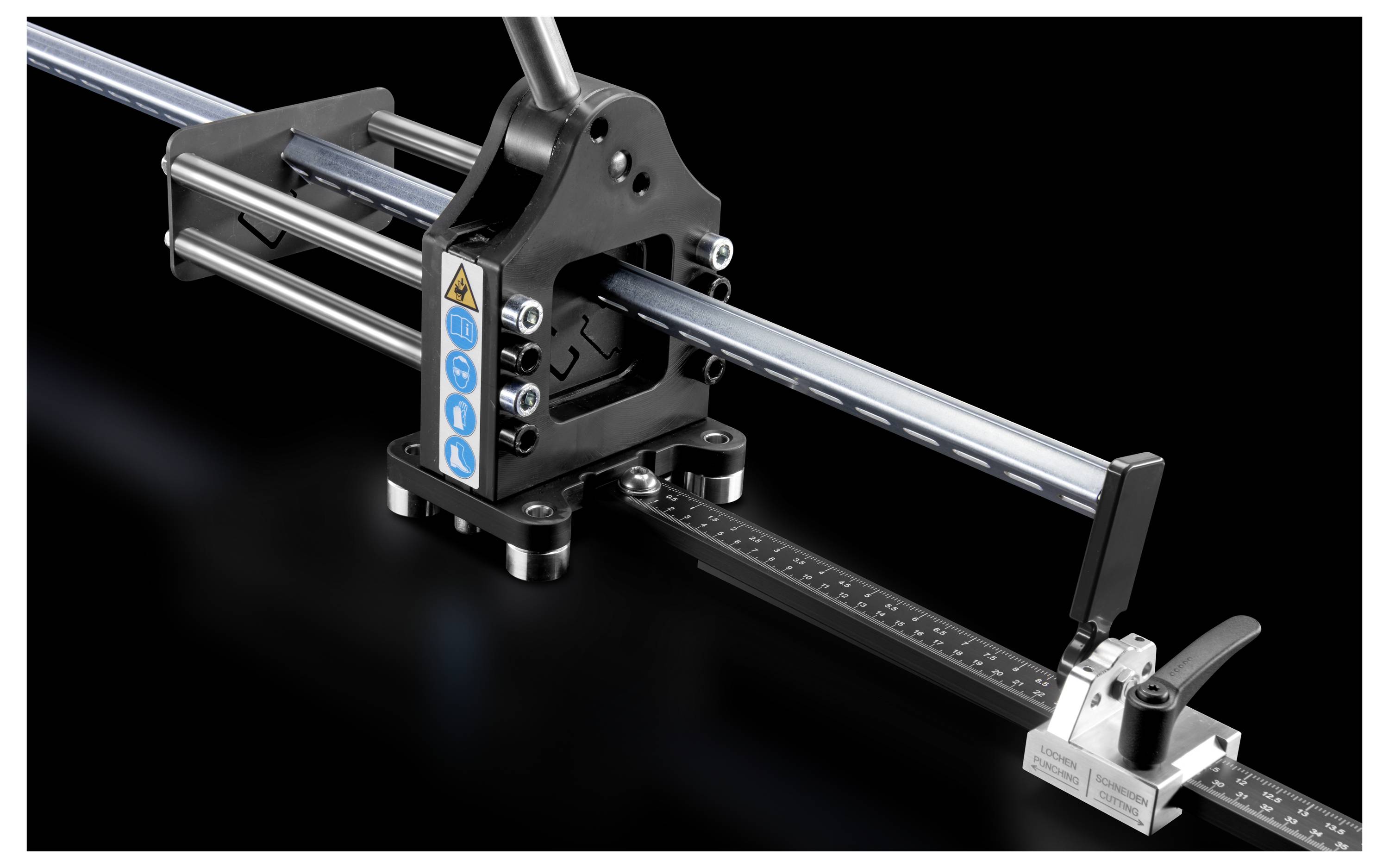 A metal machine with a black body and silver parts on a black background. It displays a measuring tool with a blue scale.