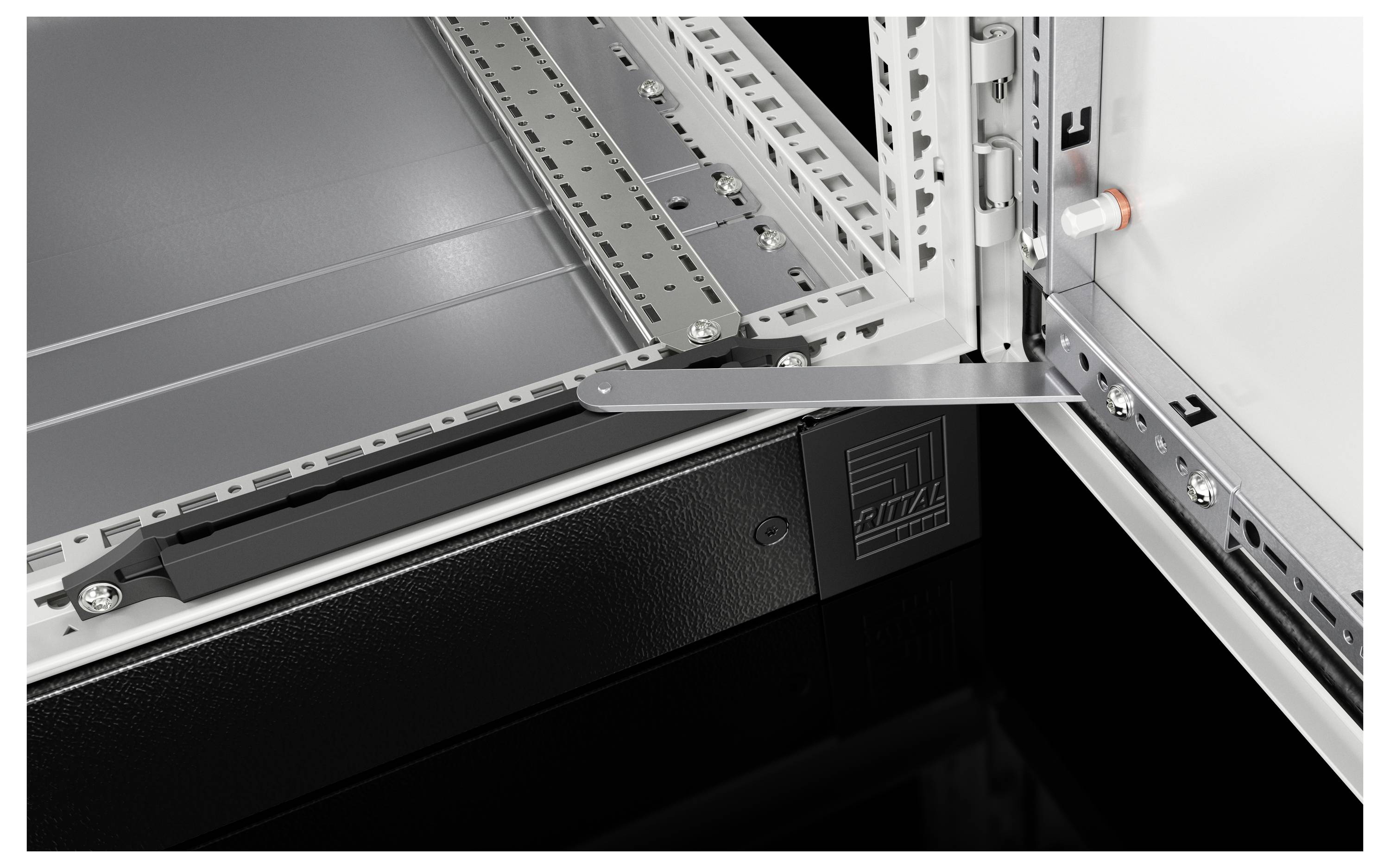 An open electrical cabinet with a grey enclosure and a distinctive black element in the foreground displaying a logo.