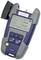 Handheld optical power meter with display indication: 4.28 dB and 7.42 dB at 1310 nm and 1550 nm. Control buttons underneath.