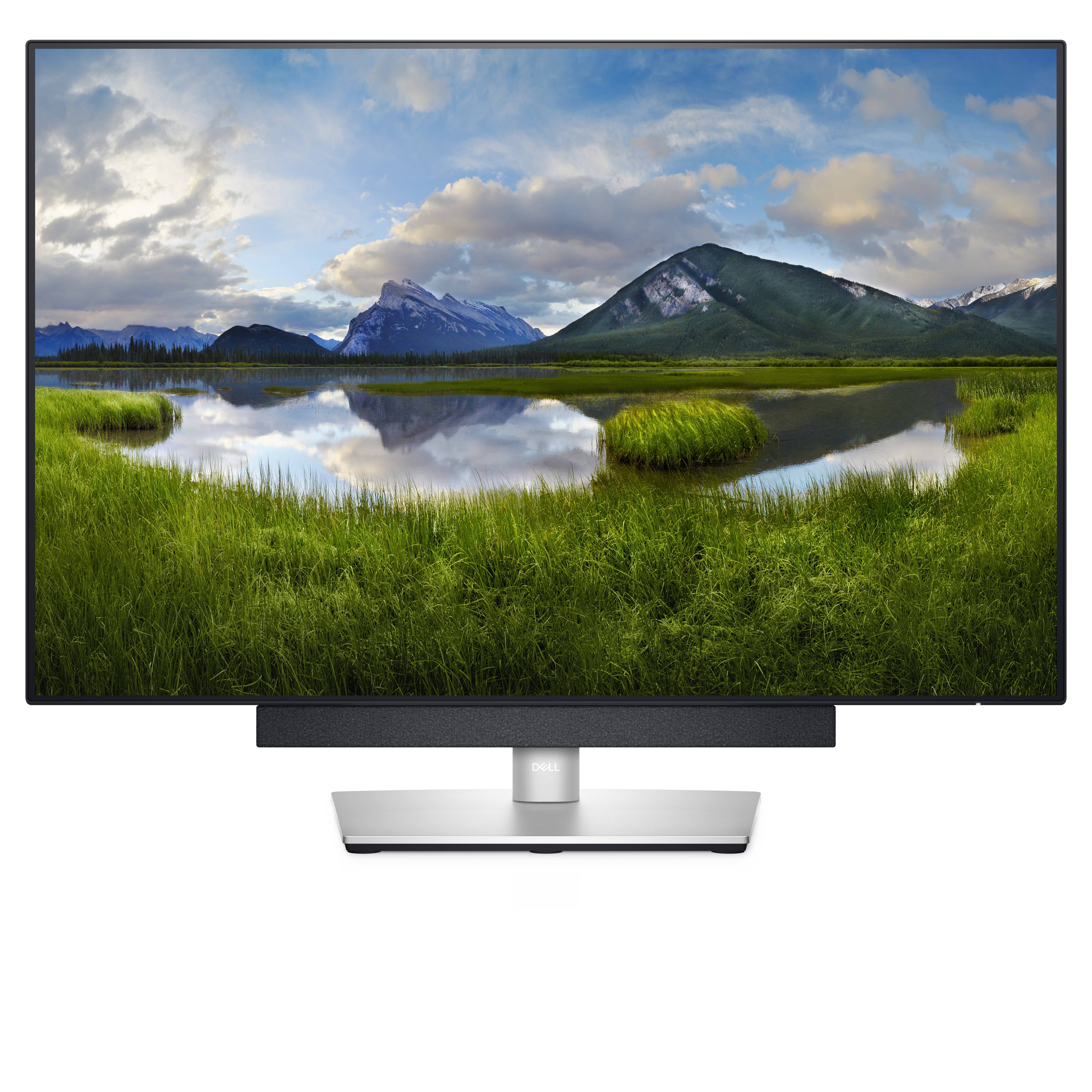 A monitor displays a landscape with a lake, surrounded by green meadows and tall mountains beneath a cloudy sky.