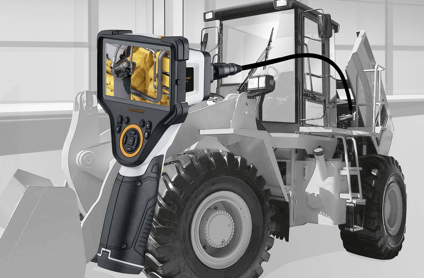 A handheld device with a display is used to inspect a large construction or industrial vehicle to examine its internal structures.