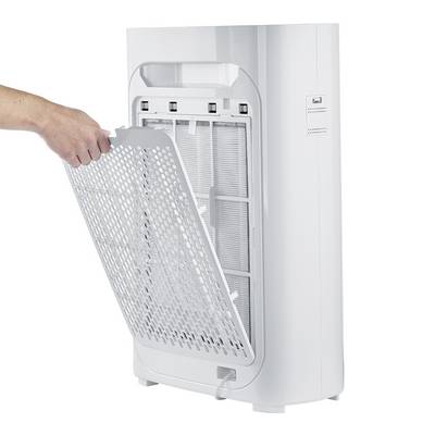 A person removes the filter from a white air purifier. The filter is rectangular and mesh-like, suitable for device maintenance.