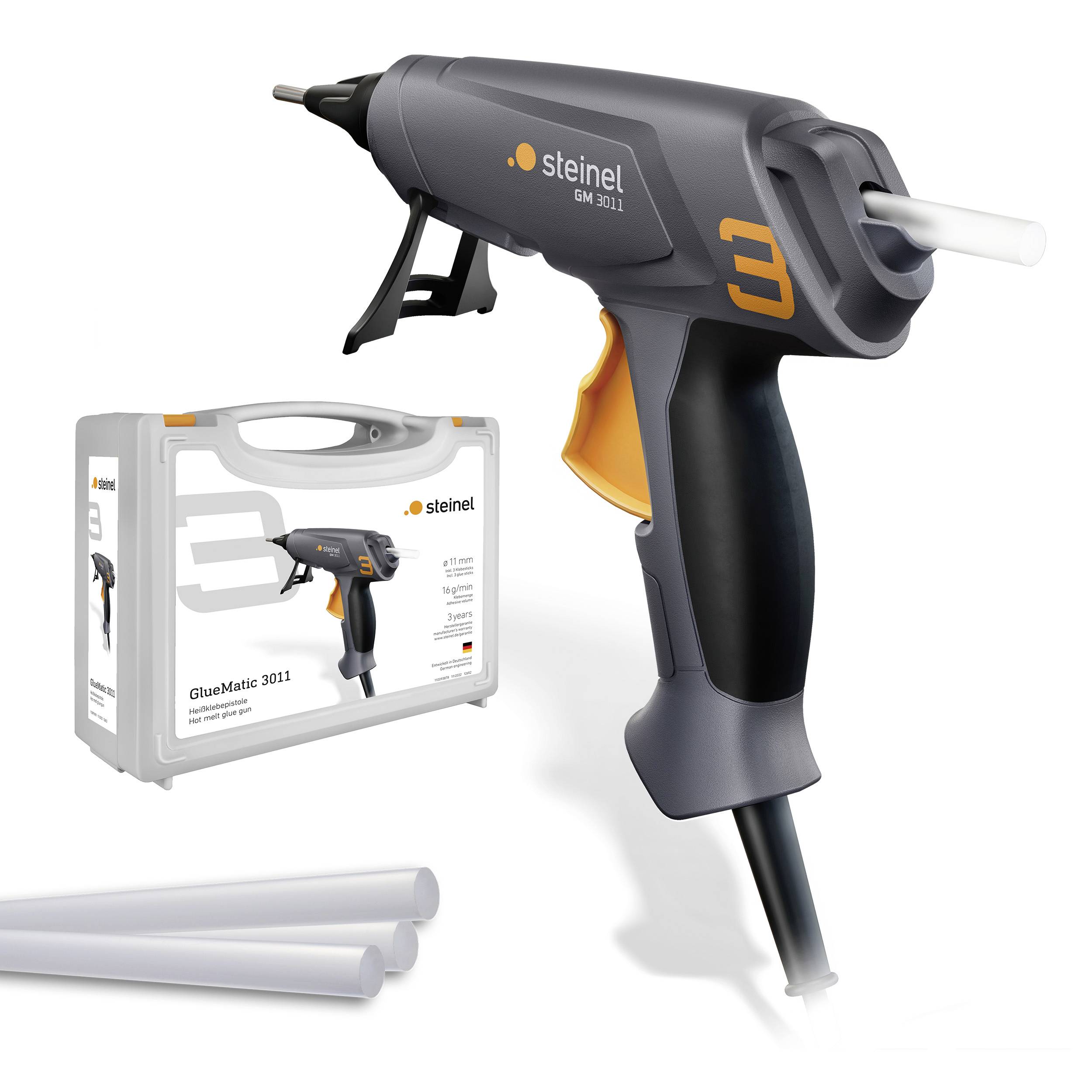 A black hot glue gun by Steinel with cable and trigger. Next to it on the right, a packaging and two glue sticks.