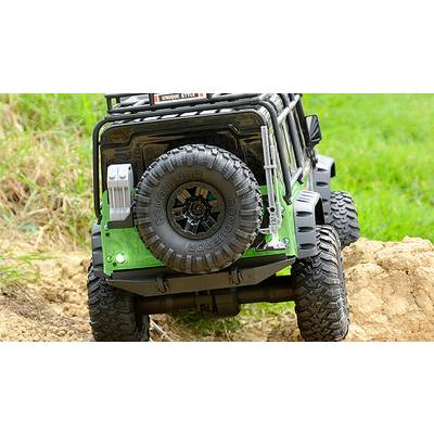 A model off-road vehicle drives over challenging terrain. The focus is on the tyres, which are suitable for difficult surfaces.