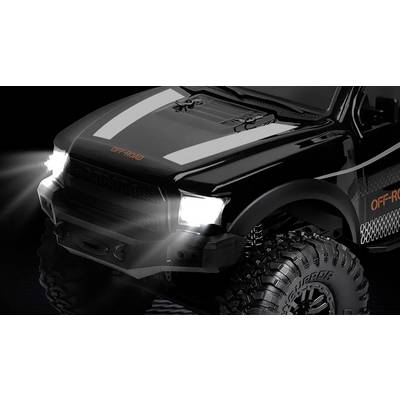 Black remote-controlled off-road car with illuminated headlamps against a dark background. Large tyres and 'OFF-ROAD' text visible.