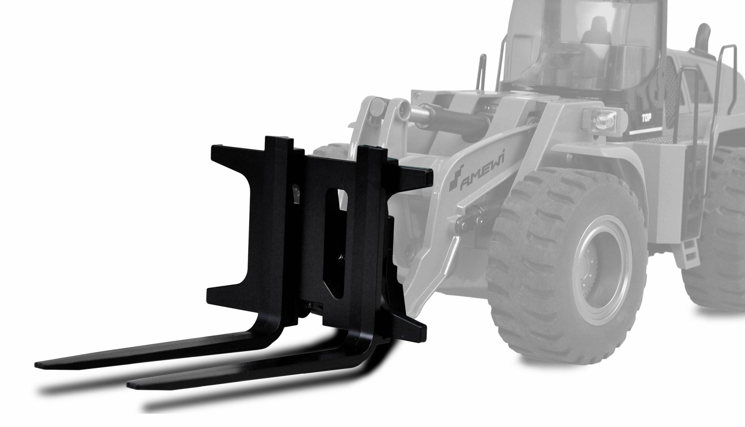 A black forklift attachment shown in front of a grey wheeled loader. The attachment has two forks for lifting and carrying loads.