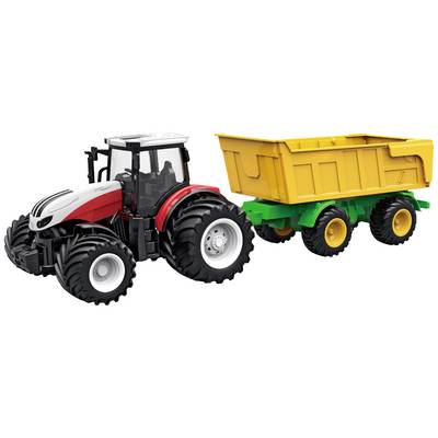 A red toy tractor is pulling a yellow trailer. The tractor has large wheels and is intricately designed.