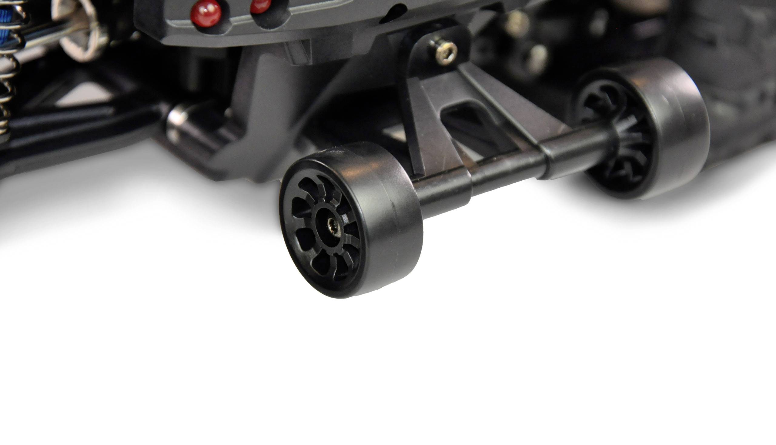 Close-up of a toy car showing the rear axle with two black wheels and a black mounting bracket against a white background.