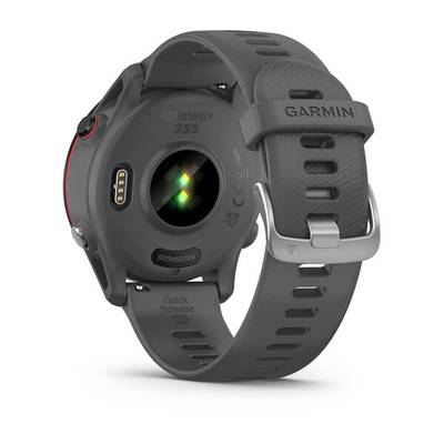 A grey smartwatch viewed from behind, showing the heart rate sensor and charging contact design.