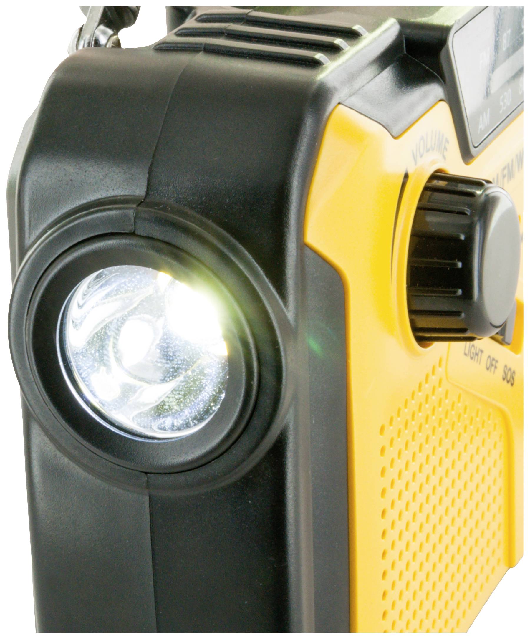 Portable yellow torch with FM radio system and side volume control, switched on and illuminating.