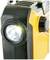 Portable yellow torch with FM radio system and side volume control, switched on and illuminating.