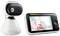 Baby monitor with camera on the left and screen on the right showing a smiling baby on the display. Device for monitoring infants.
