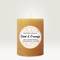 An orange-coloured scented candle with a label. Text reads: 'Cinnamon & Orange', handmade from soy wax in Bavaria.