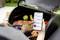 A person is grilling meat and vegetables and monitoring the temperatures using an app on their smartphone.