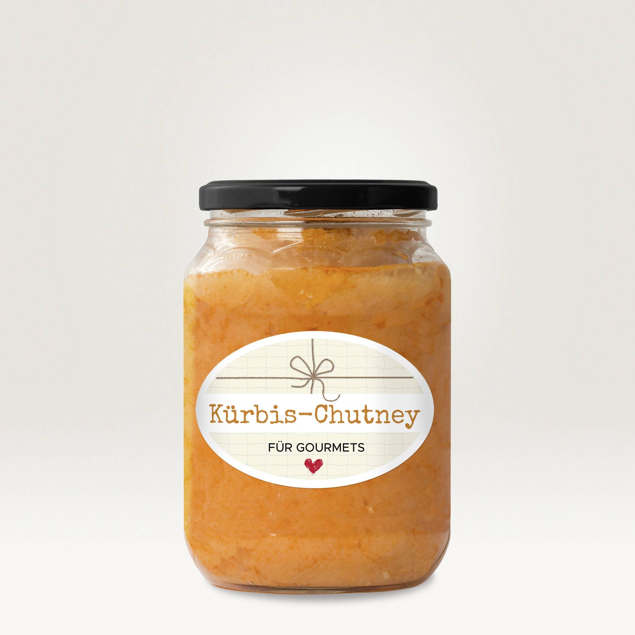 A jar of pumpkin chutney with the label 'For Gourmets' on it, against a neutral background.