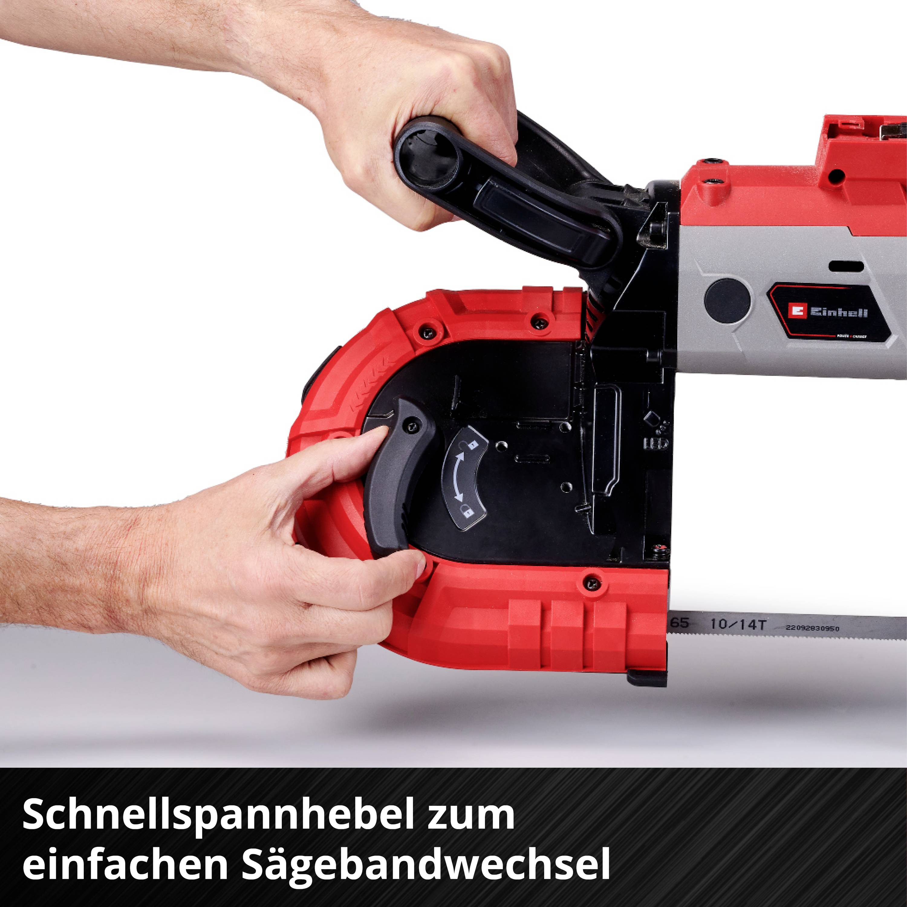 A person is holding a red power tool with a black quick-release lever that enables rapid changing of saw blades.