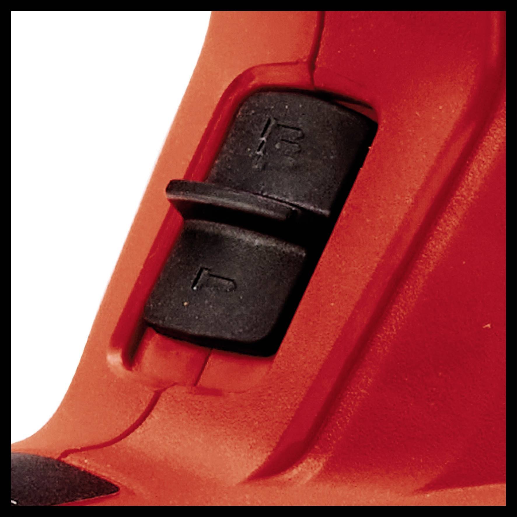 Close-up of a black switch on a red device. The switch has two positions, top and bottom, with markings.