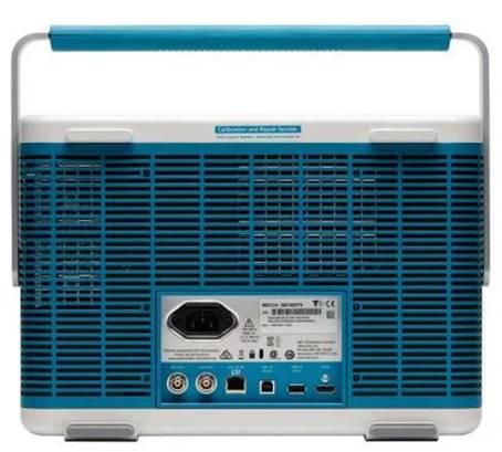 Rear view of a portable device with a handle, ventilation grilles, and connectors for power, USB, and other connections at the bottom.