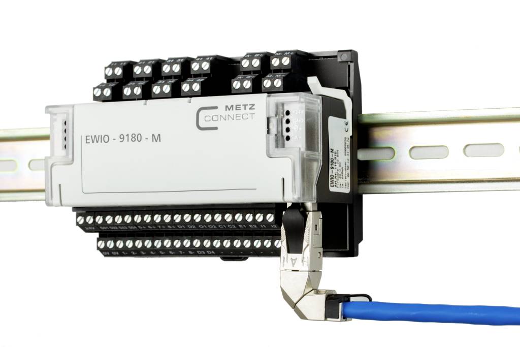 An Ethernet device is mounted on a DIN rail, connected with a blue cable. It has multiple rows of connection terminals.
