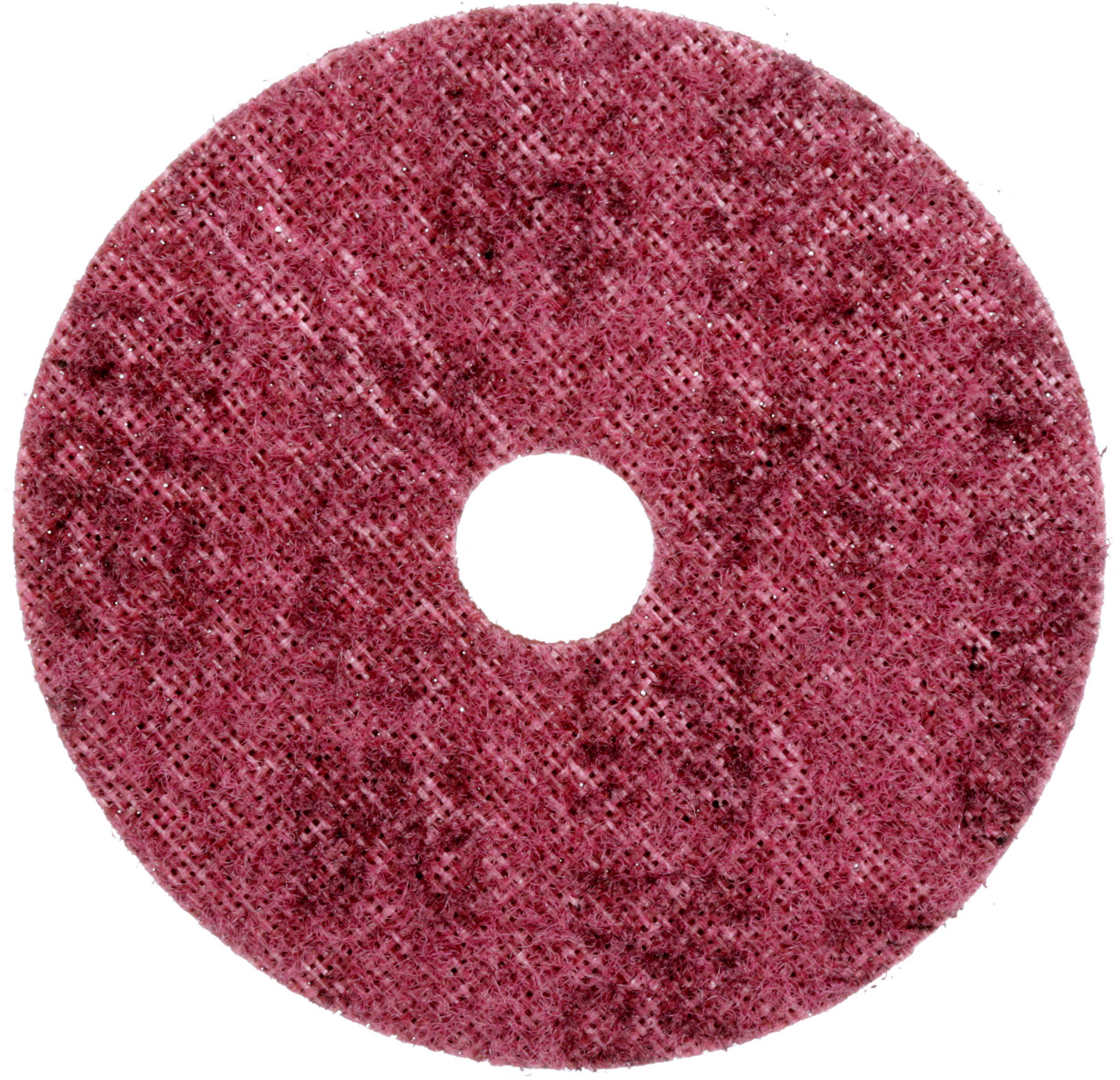 A red, round cleaning pad with a rough texture and a hole in the centre for floor cleaning.