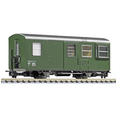 A green model railway goods wagon on a track.