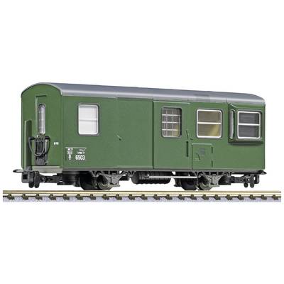 Green railway carriage on tracks in model railway scale, with windows and doors, detailed replica for model building.