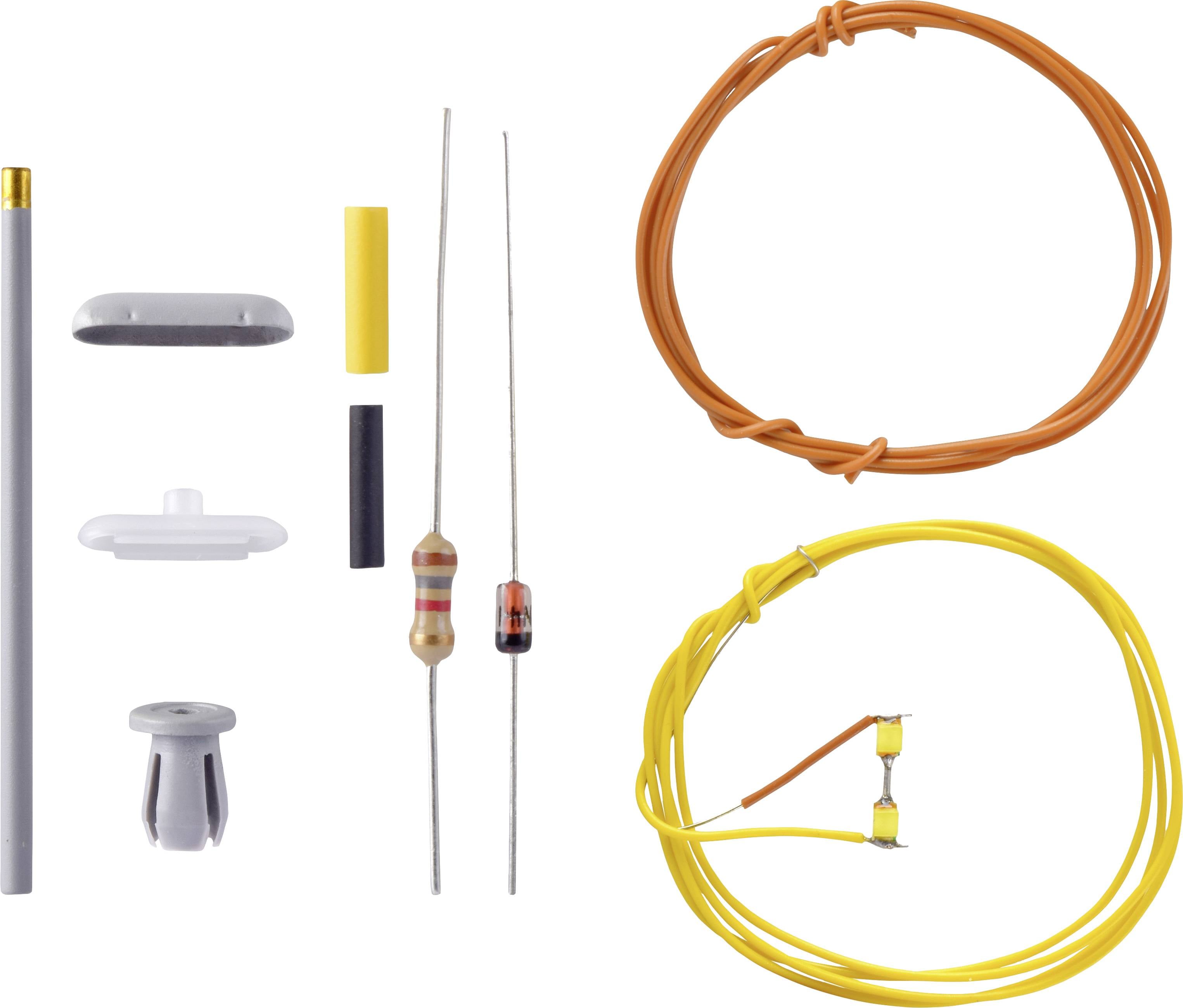 A kit with various electronic components: resistors, wires in orange and yellow, along with plastic sleeves and metal pins.