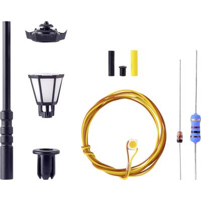 Components of a model street lamp construction kit, consisting of a lamp post, lampshade, wires, and resistors.