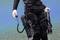 Diver in a wetsuit underwater with two portable underwater propulsion systems attached to their legs.