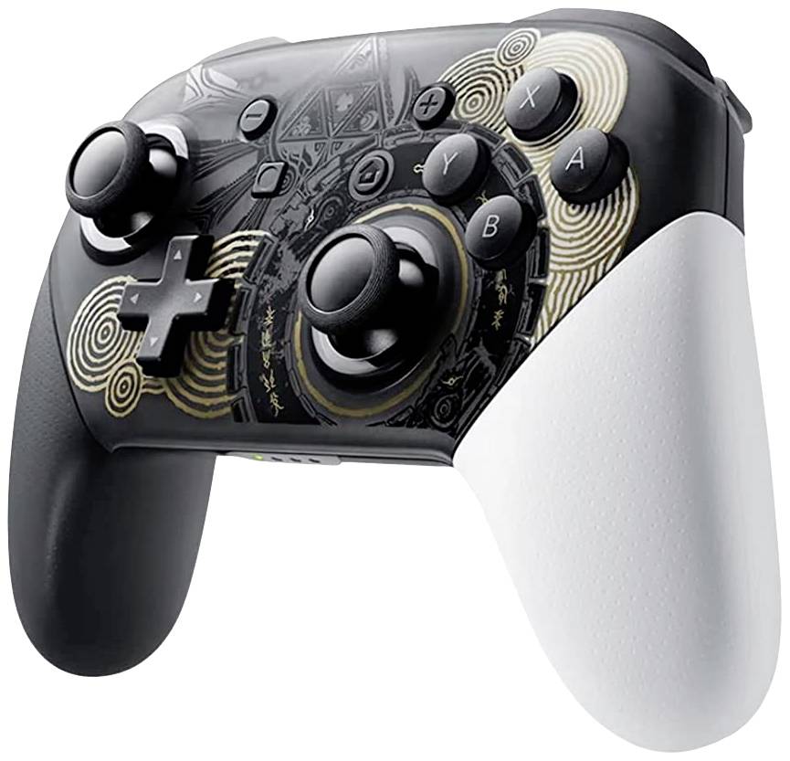 A black video game controller with white grips and a decorative golden pattern. Includes joysticks and buttons.