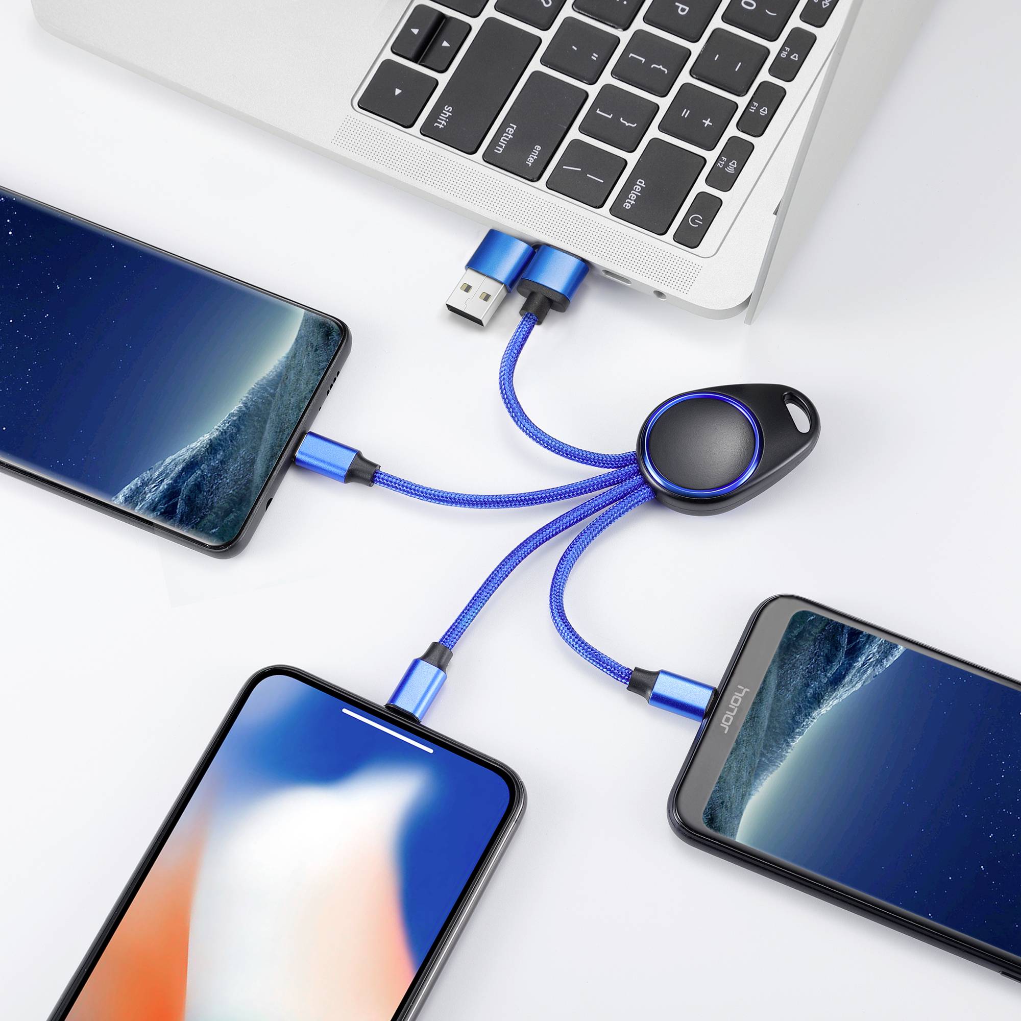 A laptop is connected to three smartphones via a multifunctional USB cable that features USB and Lightning ports.