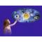 A girl points to a solar system model with various planets surrounding a central sun, against a blue background.