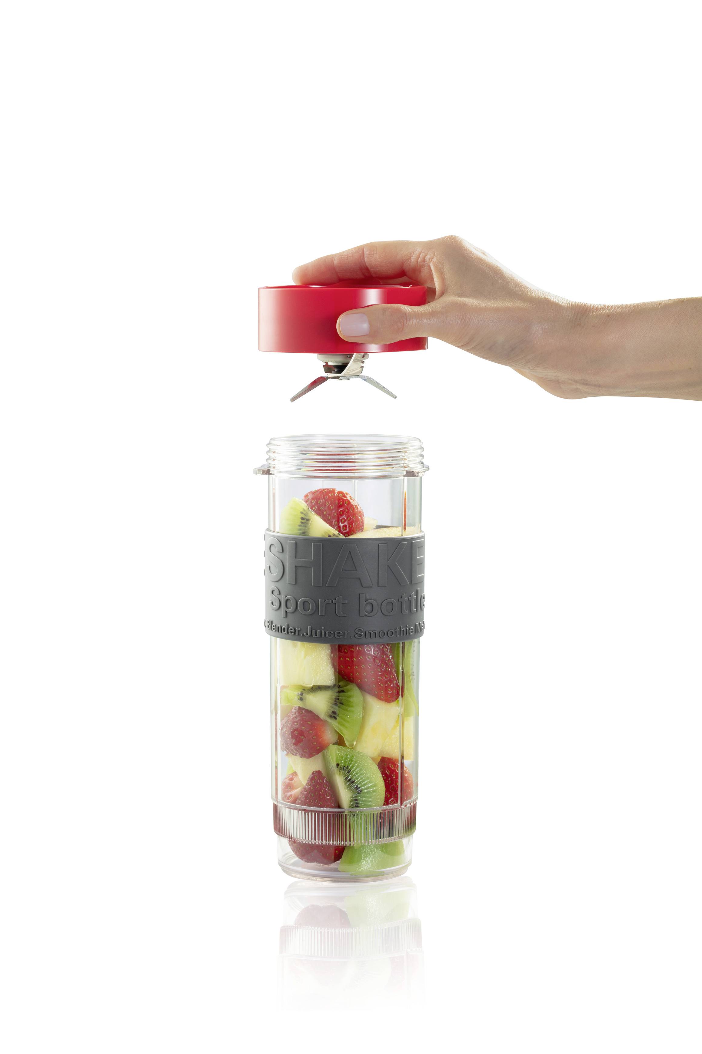 A hand unscrews the red lid onto a transparent drinking bottle filled with sliced strawberries and kiwis.