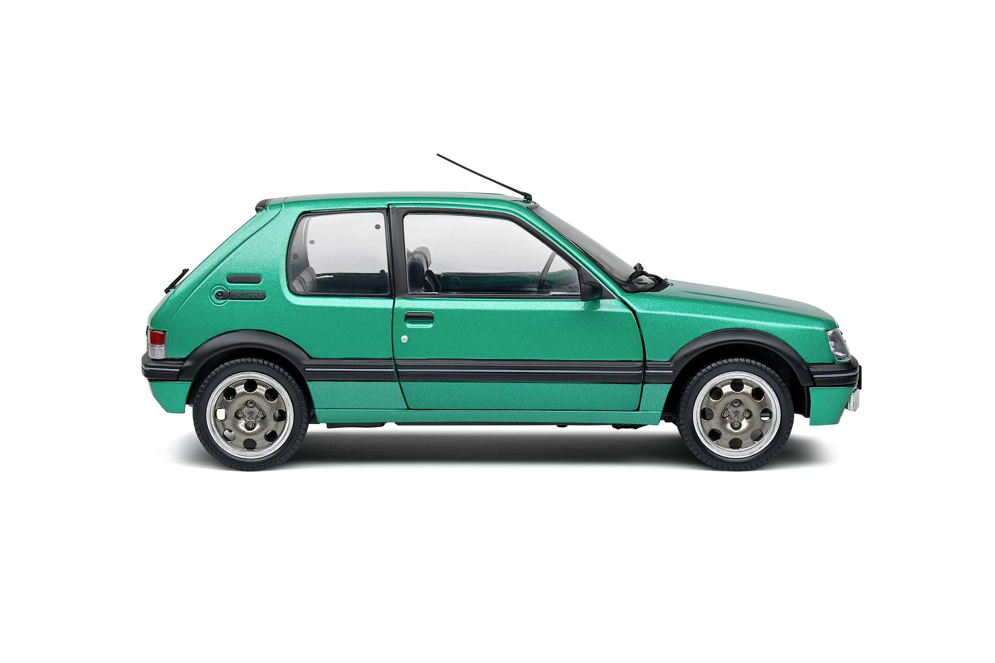 A green car pictured from the side, showing details such as windows, wheels, and bodywork, against a white background.