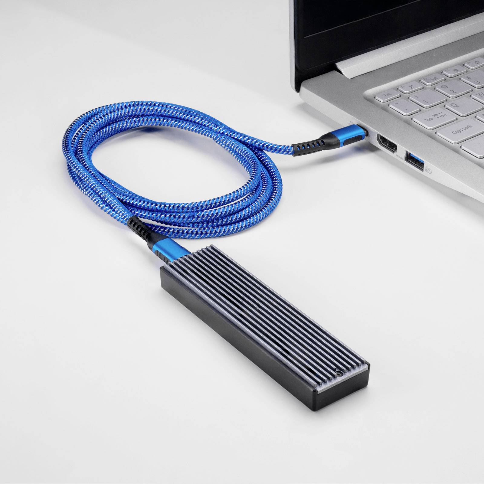 An external hard drive connection with a blue cable is connected to a laptop. Suitable for data transfer and storage expansion.