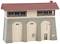 A model of a signal box with the inscription 'Freilassing'. The building has a red pitched roof, stone arch walls, and several windows.