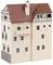 A model of a medieval half-timbered building with a red roof. It has several rows of windows and a small balcony.