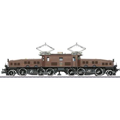 An old electric locomotive model in brown colour on a track, with six large wheels and two pantographs on the roof.