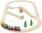 Wooden train set with tracks, a bridge and three coloured carriages. Two green trees as decoration on an oval track.