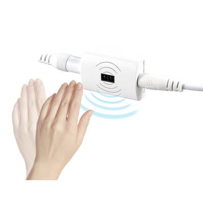 A hand approaches a sensor on an electrical device with cables, which emits waves to detect touch.