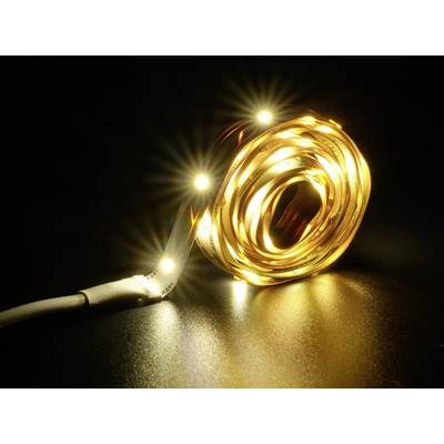 A luminous LED light strip in a warm yellow tone, coiled on a dark surface. Radiating a soft, intense light.