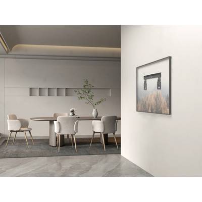 An elegant, modern dining room with a round wooden table, four beige chairs, and a wall painting of an autumnal landscape.