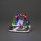 Christmas diorama with illuminated pine trees, a Father Christmas with sleigh and a glowing 'Merry Christmas' arch.