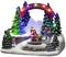 Festive scene with an illuminated 'Merry Christmas' arch, Father Christmas, sleigh and children amongst lit-up pine trees.