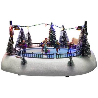 A Christmas decoration shows figures ice skating in a small arena, surrounded by snow-covered trees and colourful lights.
