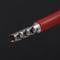 Close-up of a red, isolated cable with a tinned, ribbed metal terminal end.