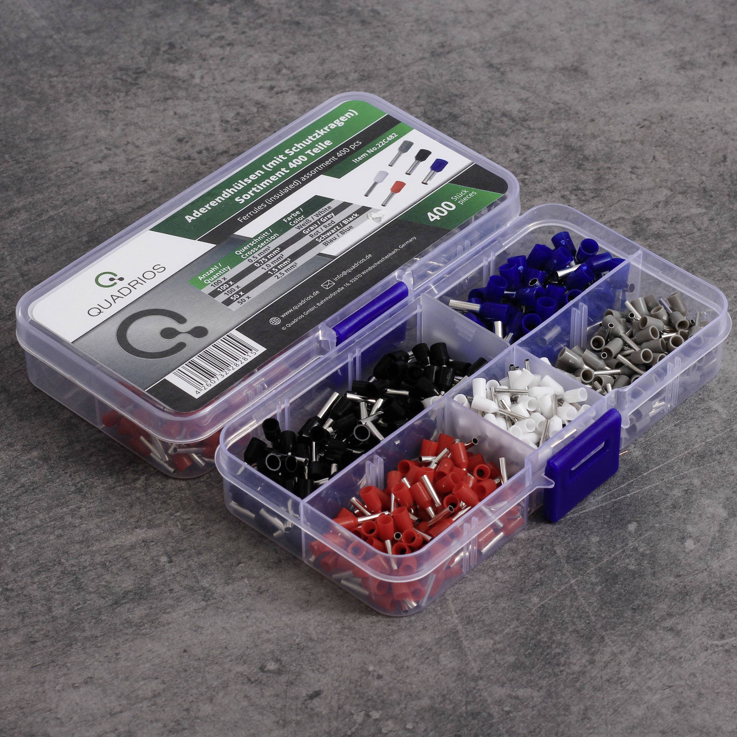 A plastic box with coloured cable shoes in different compartments shows red, black, blue, white, and grey connections.