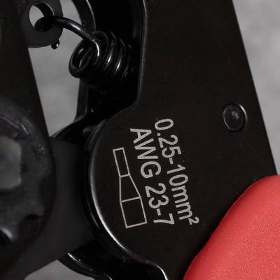 Close-up of a crimping tool with markings '0.25-10mm² AWG 23-7', showing a precision tool for electrical work.