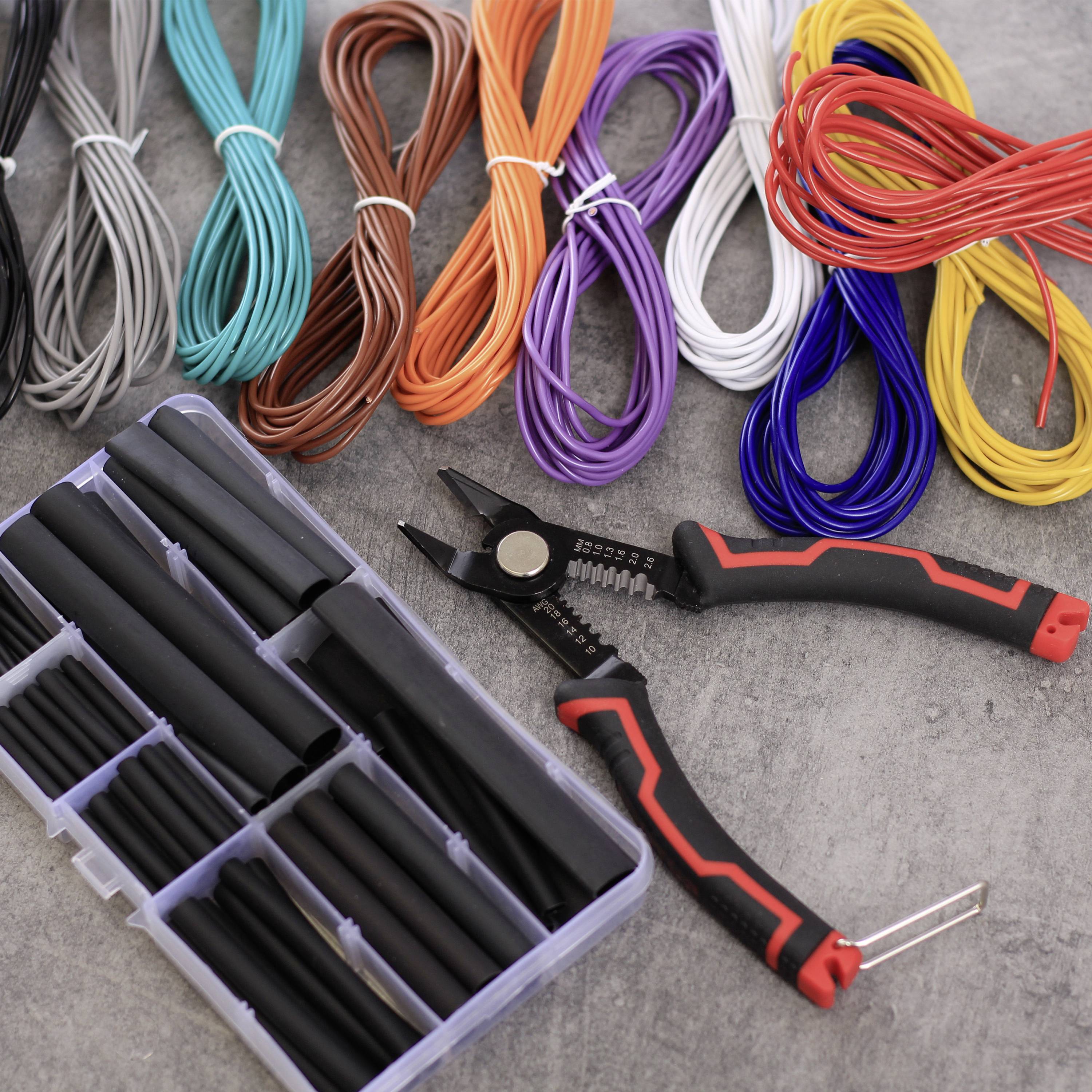 Various colourful cables in bundles, a toolbox with heat-shrink tubing and a pair of pliers on a grey surface.